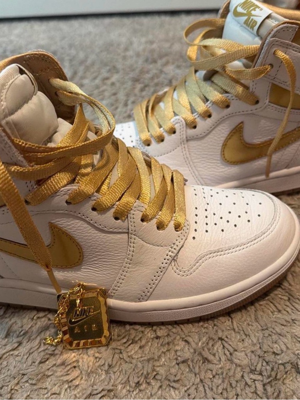 Nike Jordan 1 Women’s High-Top Sneakers in White and Gold